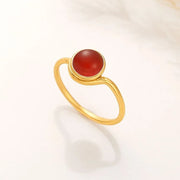 14k Gold filled ring with a round reddish carnelian stone on a white background